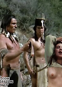 The redhead obeyed and the fifth man put his bow and arrow down and fucked her in the cunt from behind as she licked pic 3